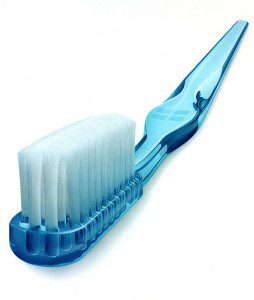 A blue toothbrush with white bristles on top of it.