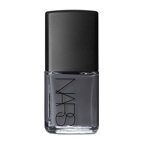 A bottle of nail polish with black label.