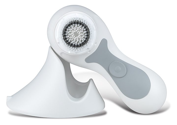 A pair of electric facial cleansing brushes on top of each other.